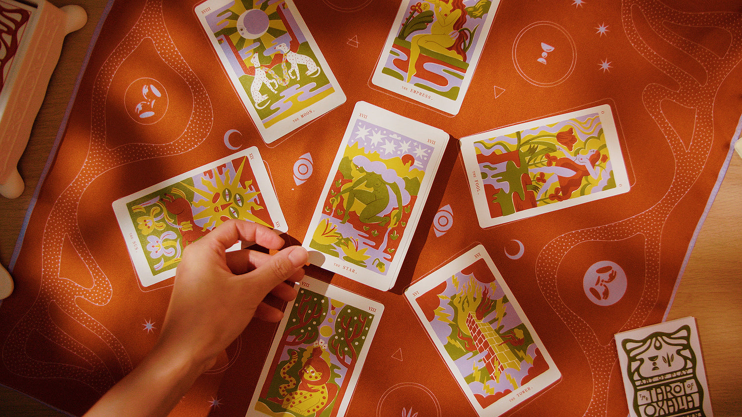 A tarot card reading on a red scarf