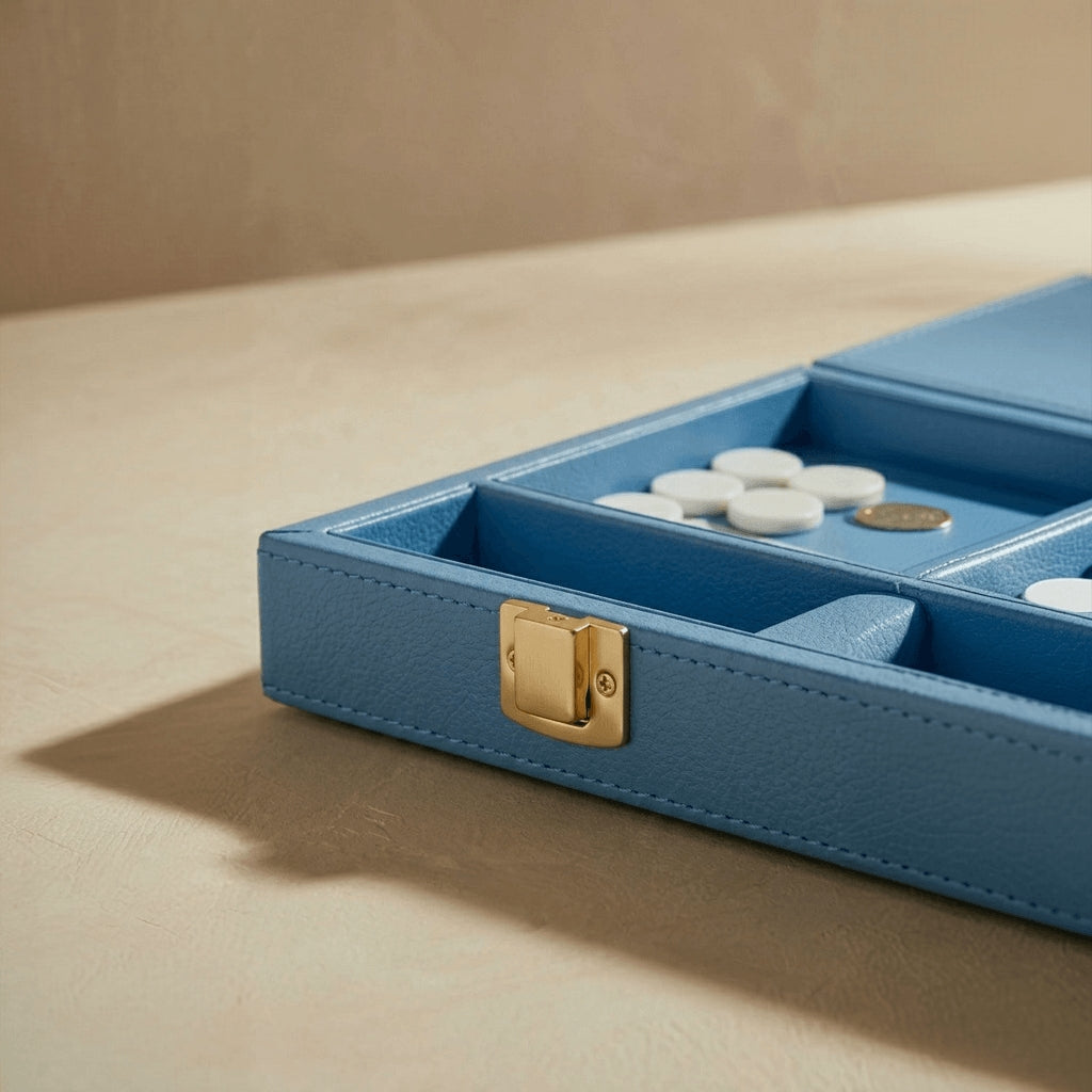 Blue jewelry box with gold clasp on a beige surface