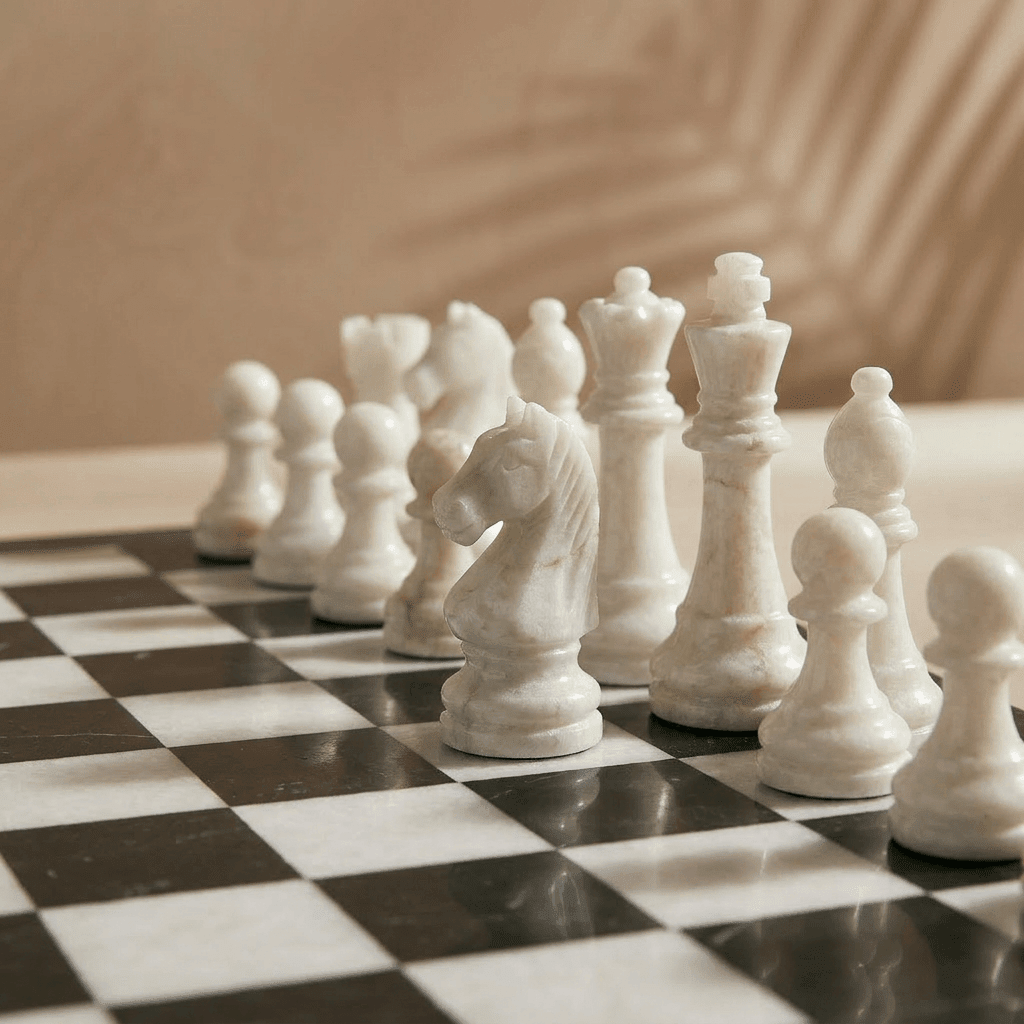 White chess pieces on a black and white checkered chessboard