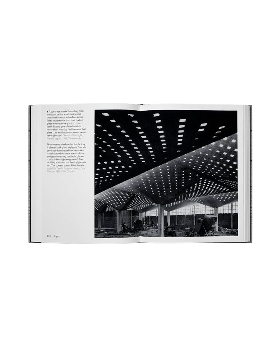 An open book showing a black-and-white architectural photograph of a large interior space with a perforated ceiling, alongside printed text on a white page.