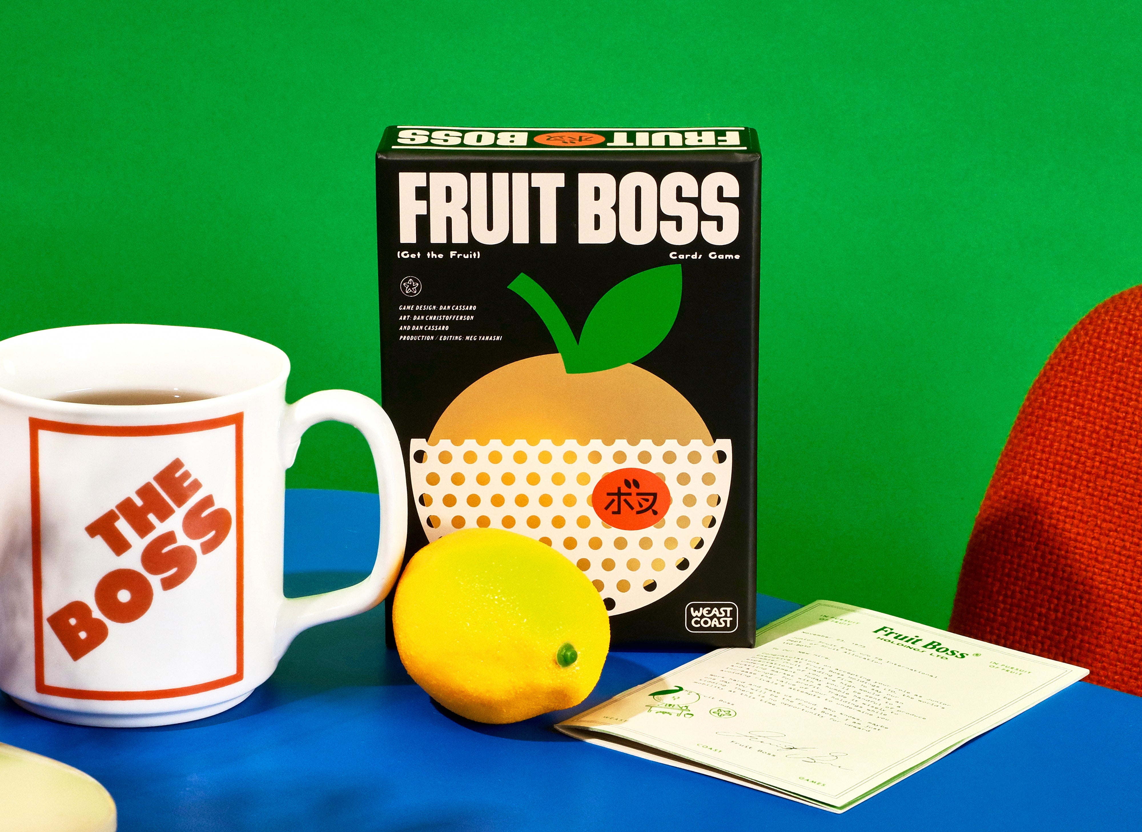 Fruit Boss game box with a mug labeled 'The Boss' and a lemon on a blue surface against a green background.