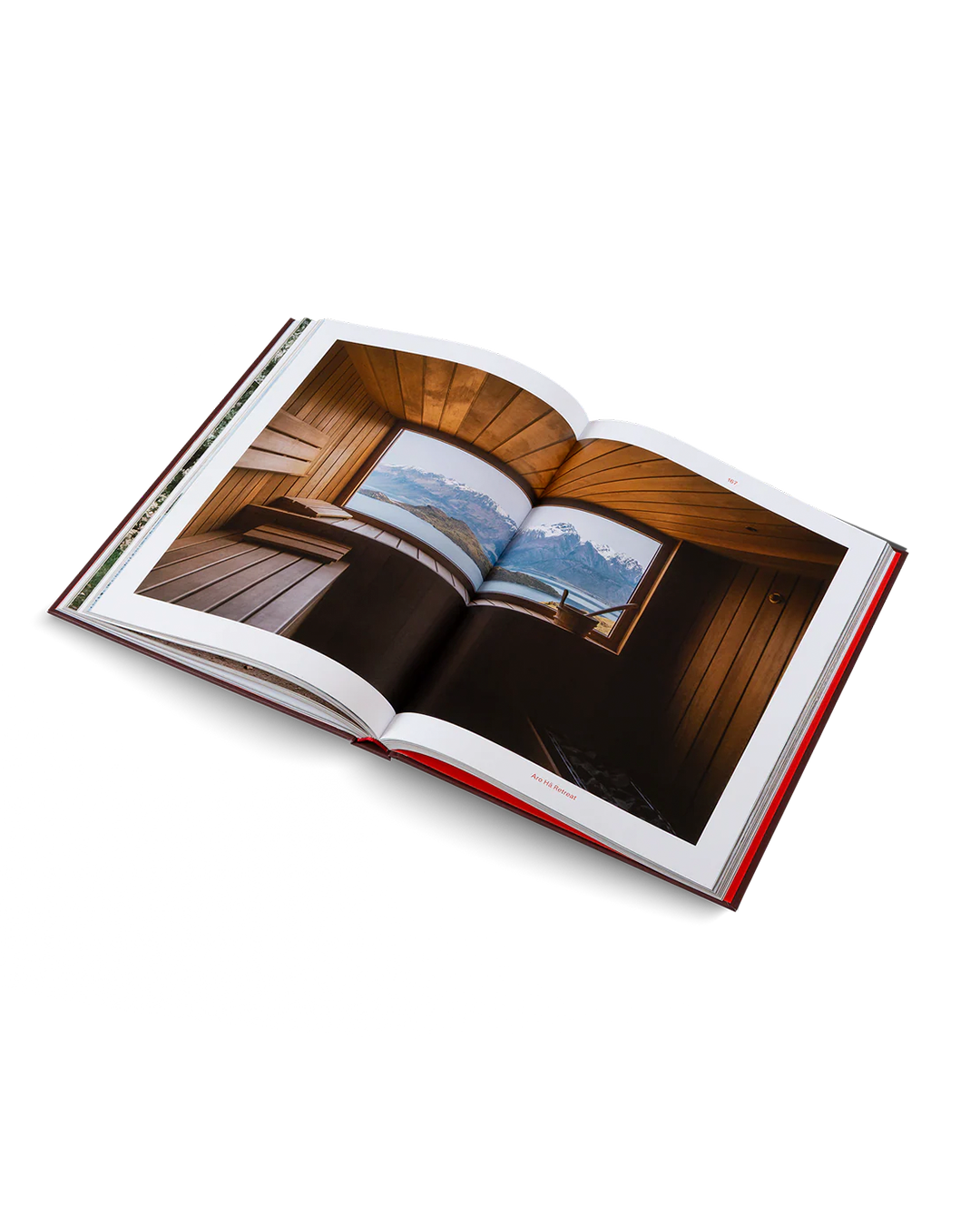 Open book showing a wooden interior with a scenic view through a window.