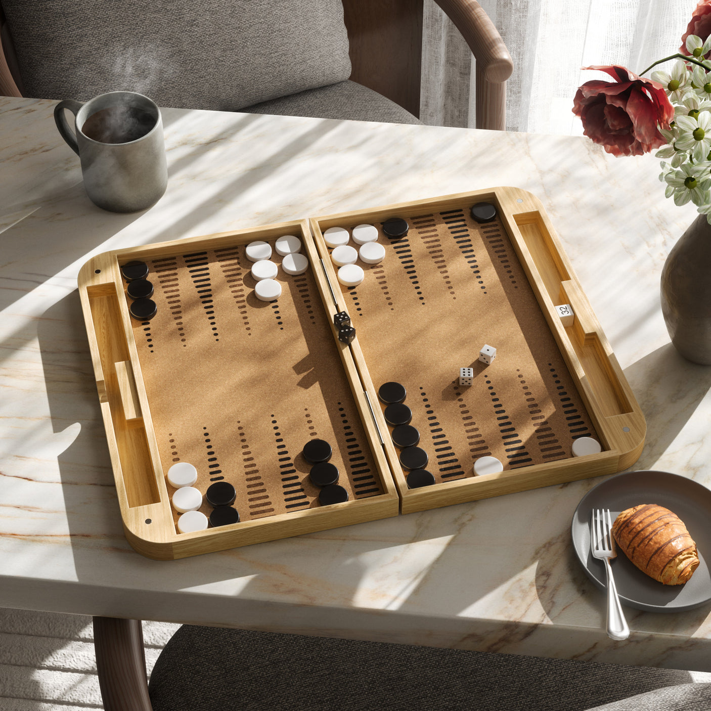 Wooden backgammon set on a marble table with a cup, plate of food, and flowers in the background.
