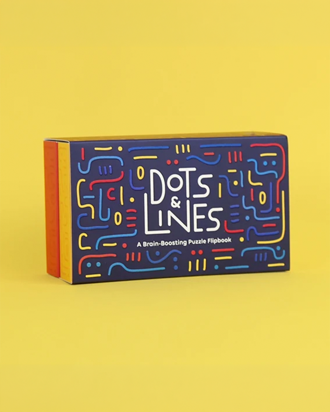 A boxed puzzle flipbook titled "Dots & Lines" standing upright on a solid yellow background. The front of the box is dark blue with colorful abstract line patterns in red, yellow, and blue, and the title is printed in large white letters.