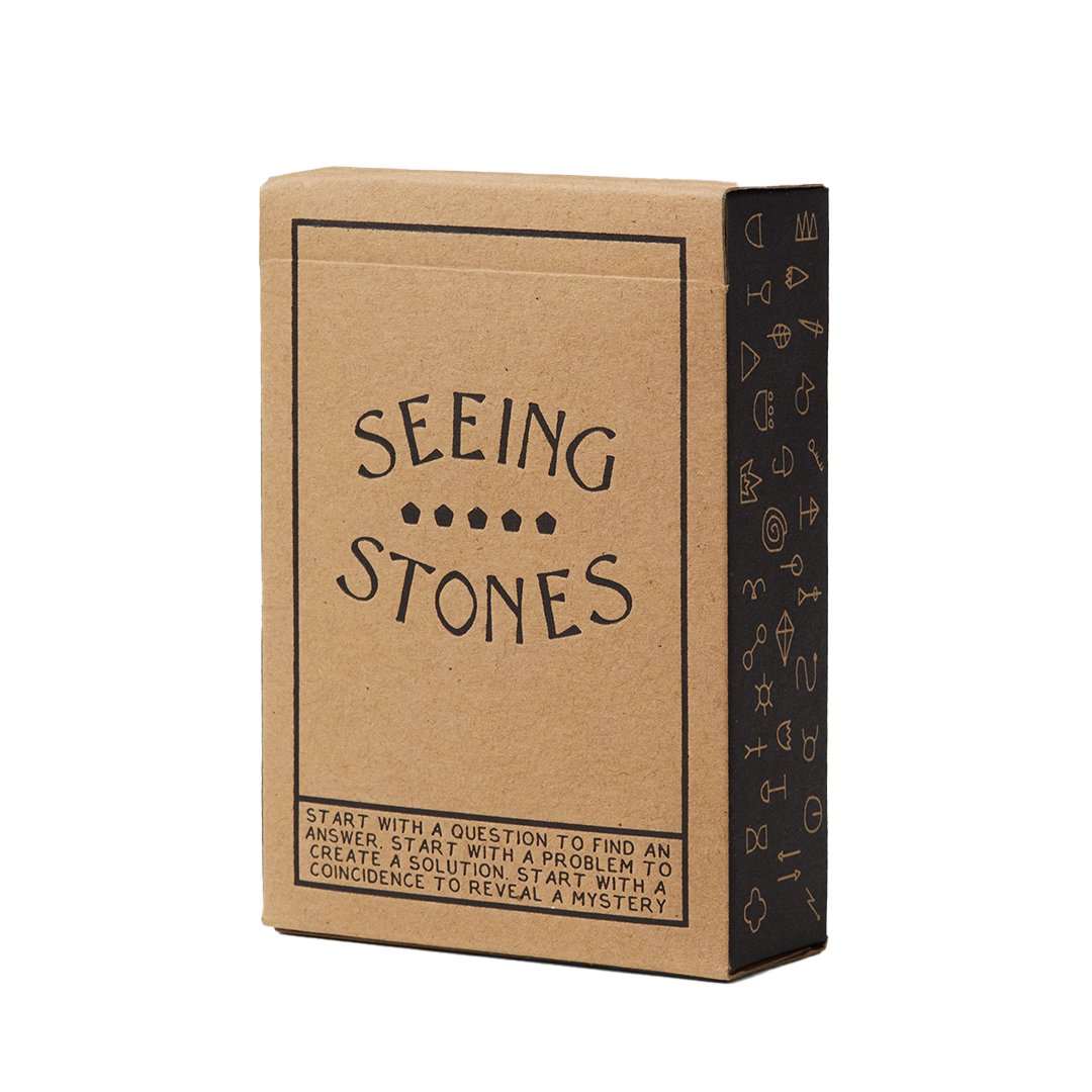 Kraft paper box with 'Seeing Stones' text on a white background