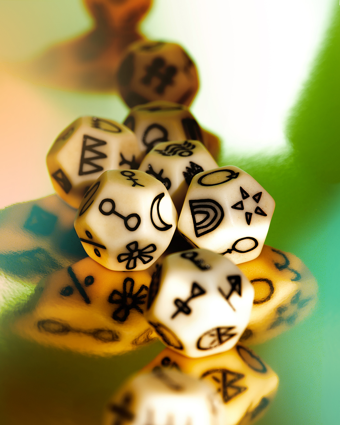Set of dice with black symbols on a reflective surface