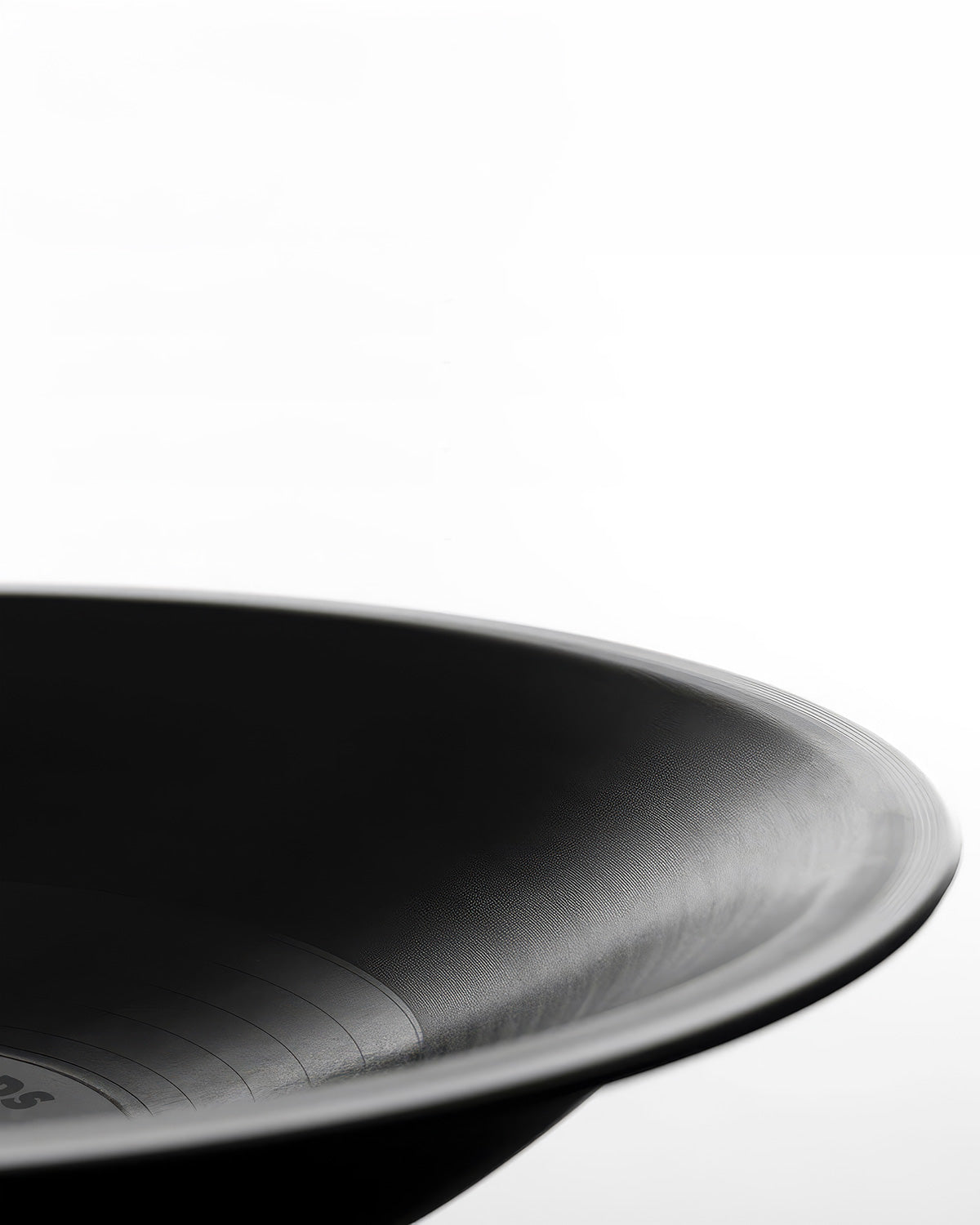 A close-up studio shot of a matte black bowl against a clean white background.