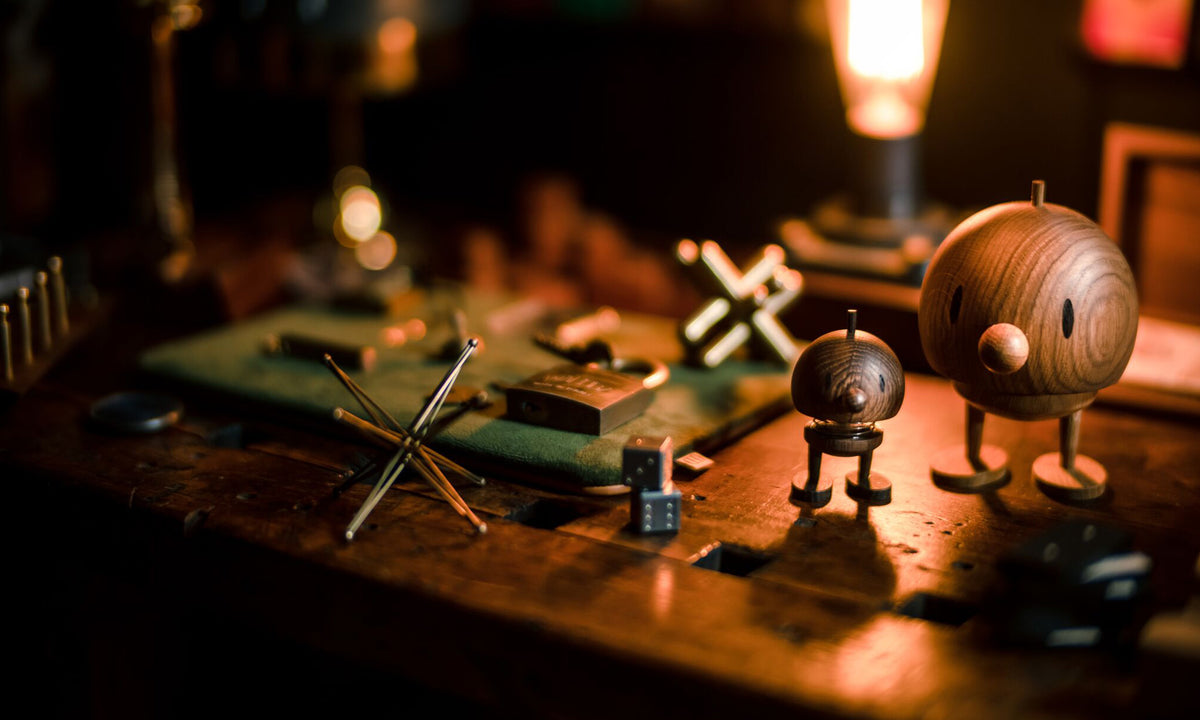 Handcrafted curiosities at Art of Play Art of Play showroom table displaying handcrafted curiosities and wooden figures