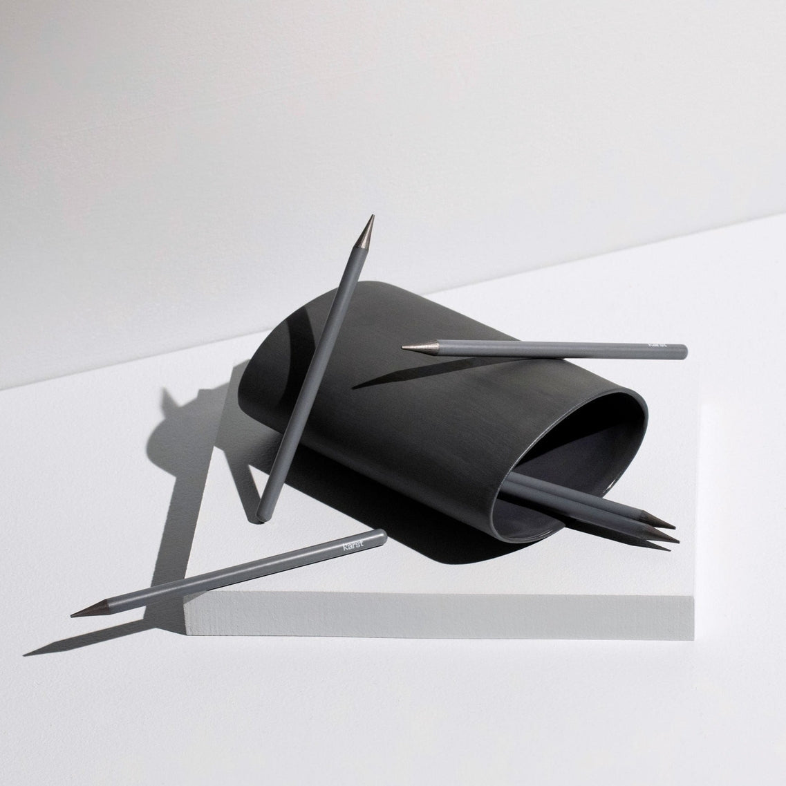 Black paper sculpture with sharp pencils on a white background