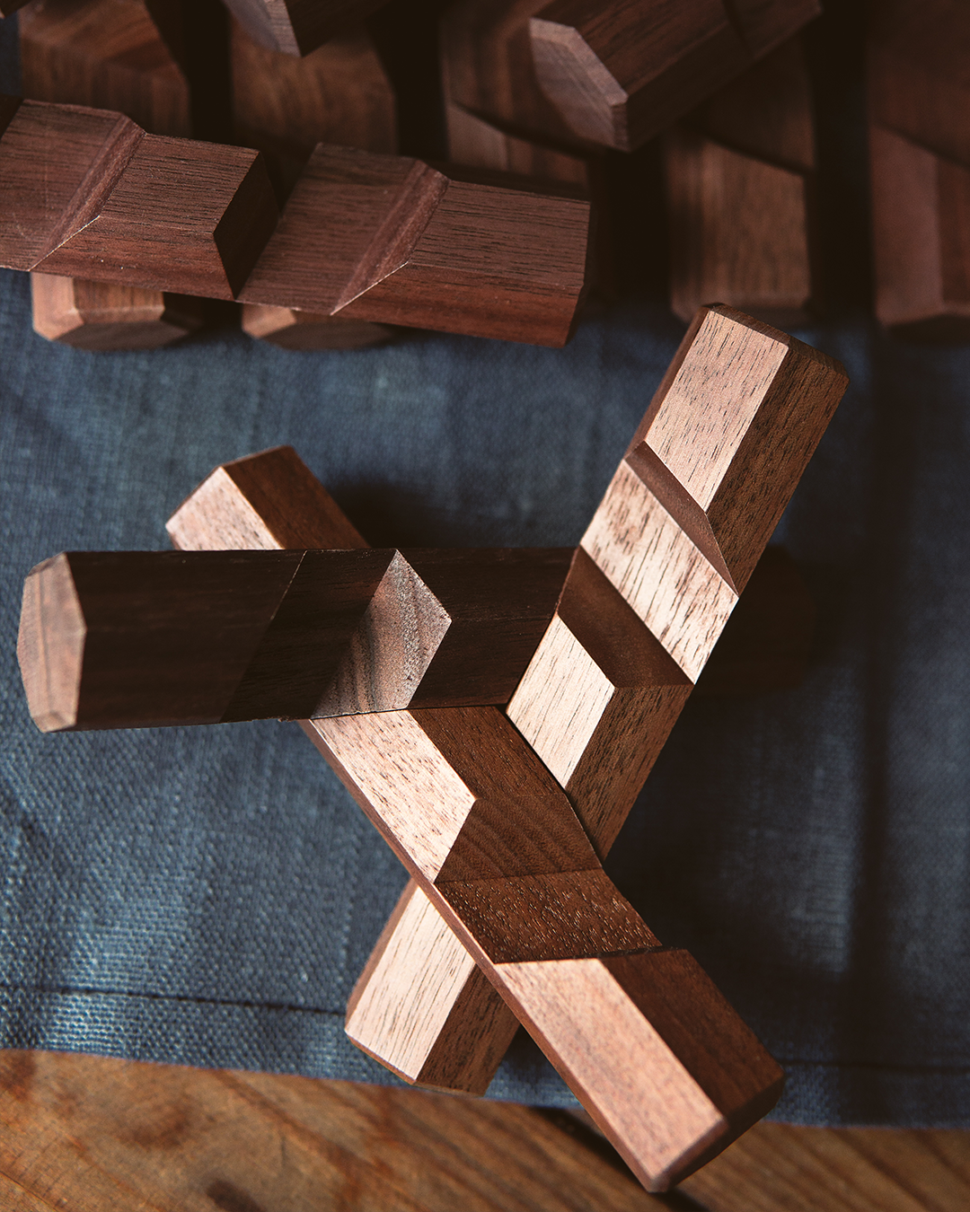 Wooden interlocking puzzle on a textured surface