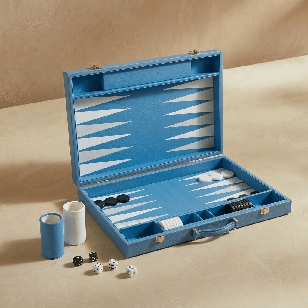 Blue backgammon set with pieces and dice on a beige surface