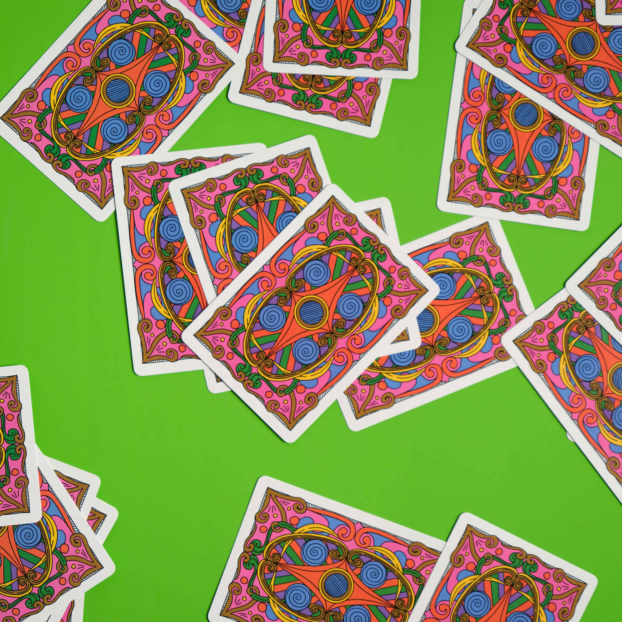 Colorful deck of cards with intricate designs on a green background