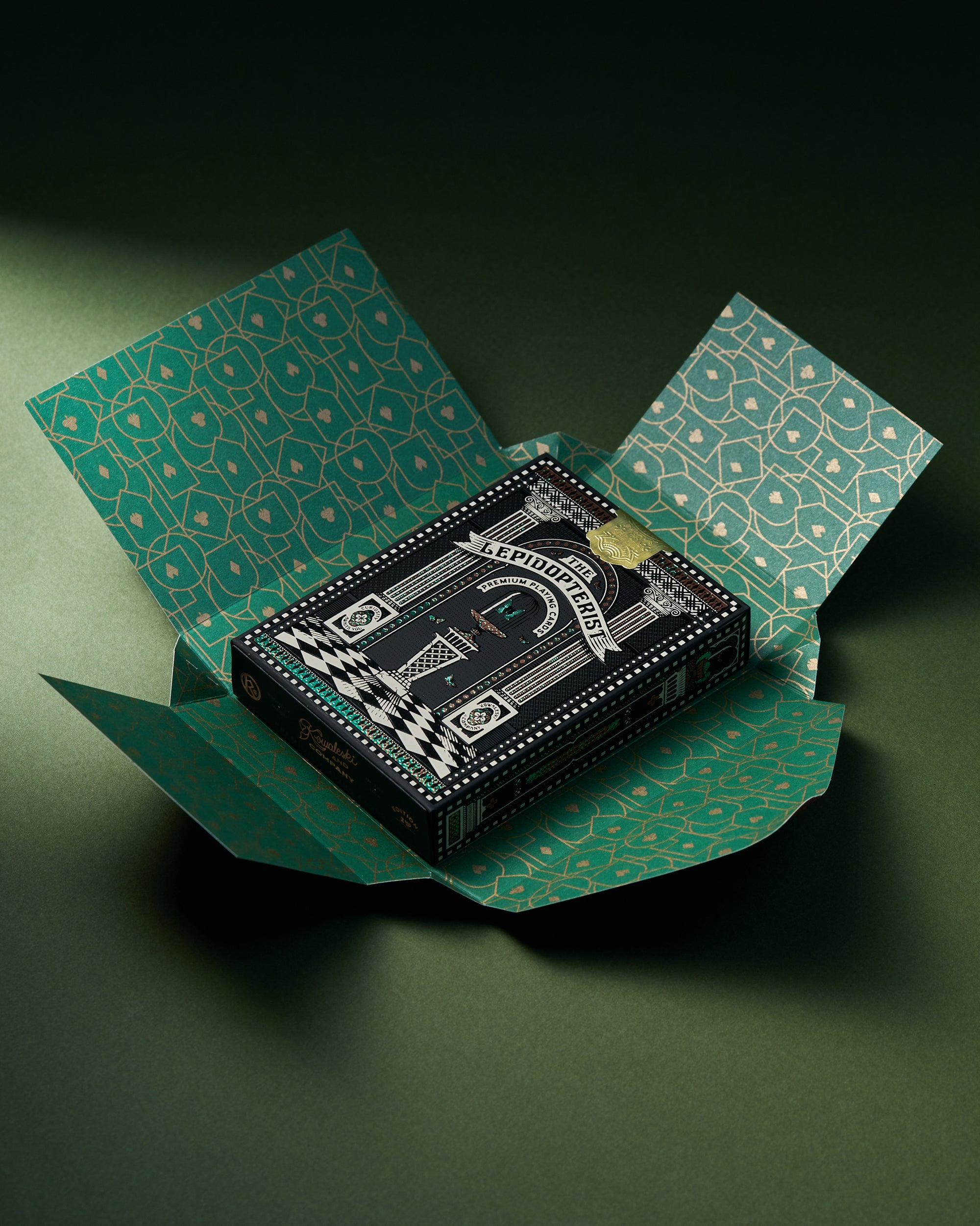 Playing cards with a decorative box on a green background