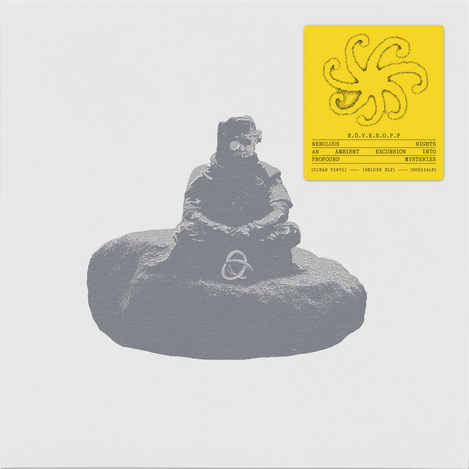 A square album or art print with a light gray background, featuring a monochrome photograph of a seated figure on a rock in the lower center and a bright yellow label in the upper right with a stylized symbol and small text.