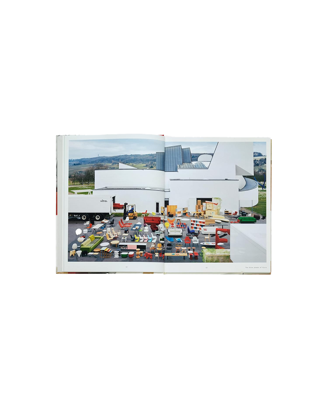 Open book showing a photograph of a modern architectural setting with colorful furniture.
