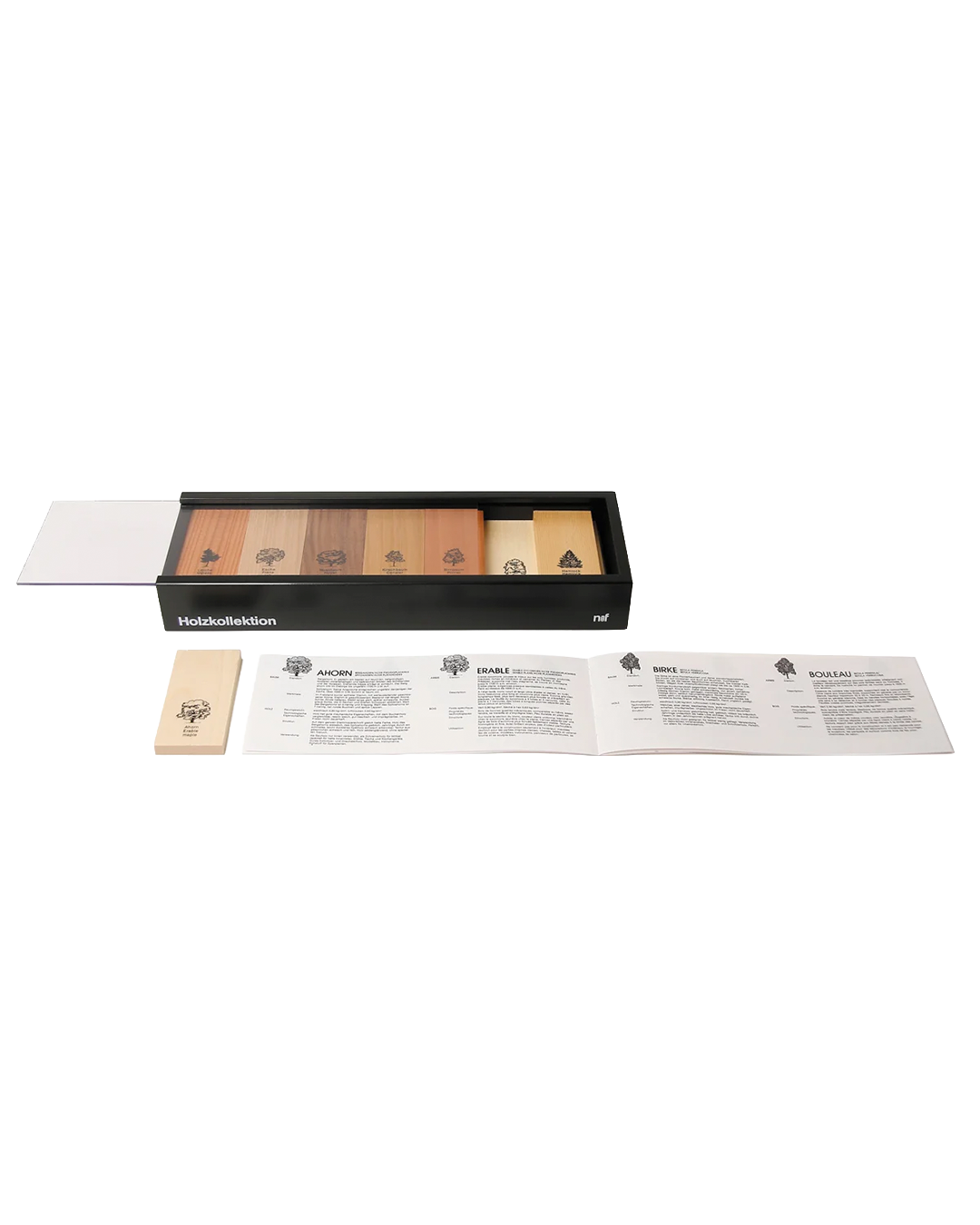 A boxed set of wooden game pieces or cards displayed on a white background, with a black tray holding several wood-toned rectangular pieces, a small wooden token, and printed instruction sheets below.