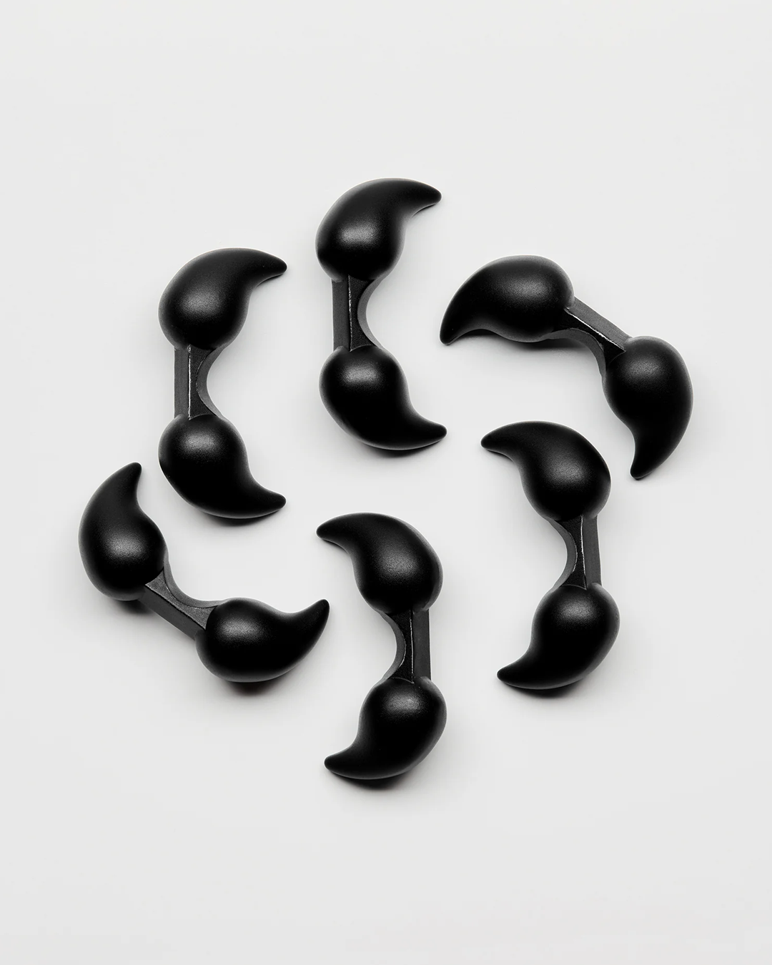 Set of black plastic clips on a white background