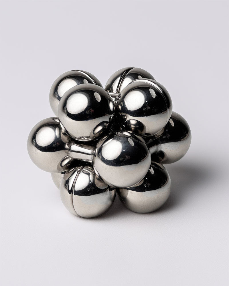Atom metal burr puzzle by Curio