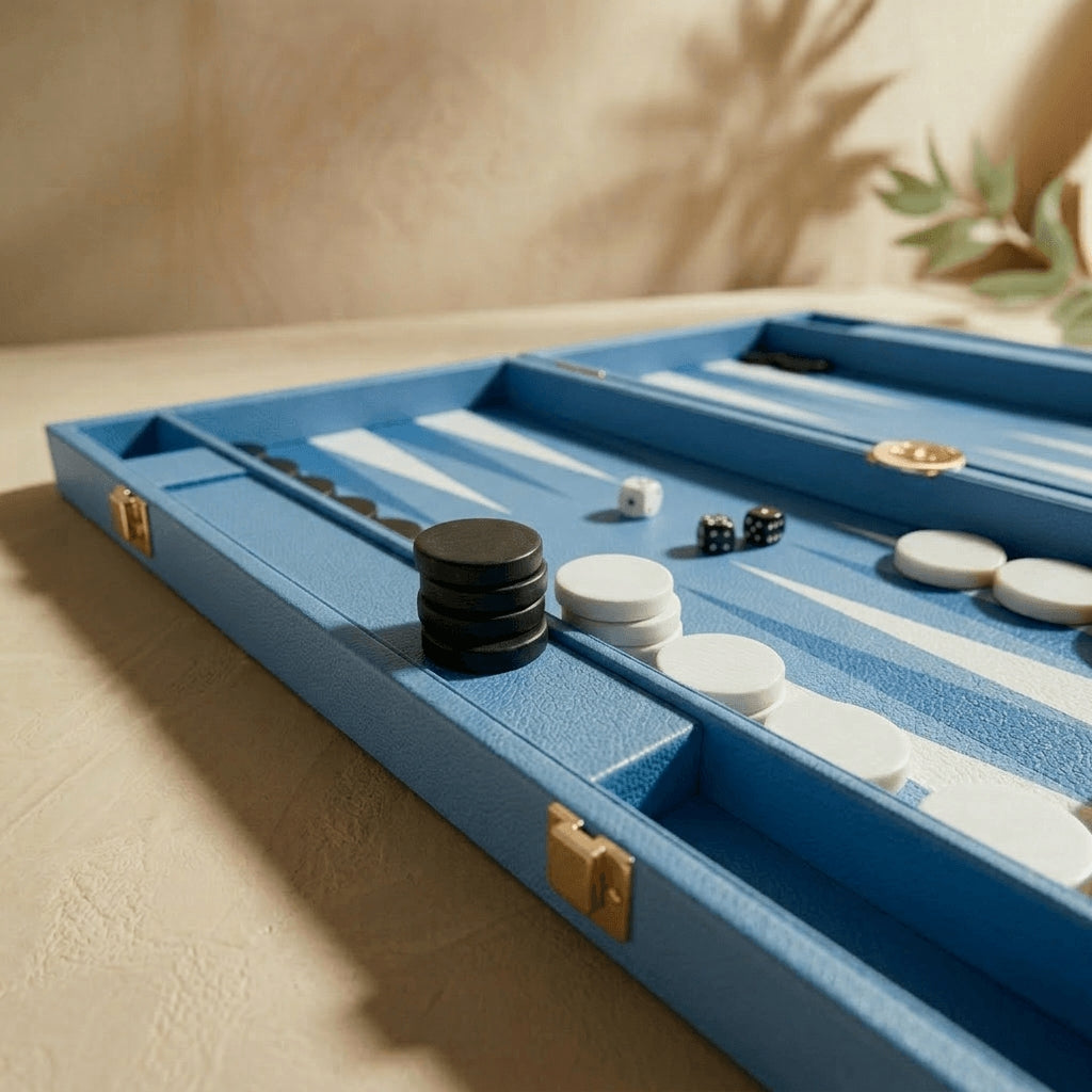 Blue backgammon set with pieces and dice on a beige surface