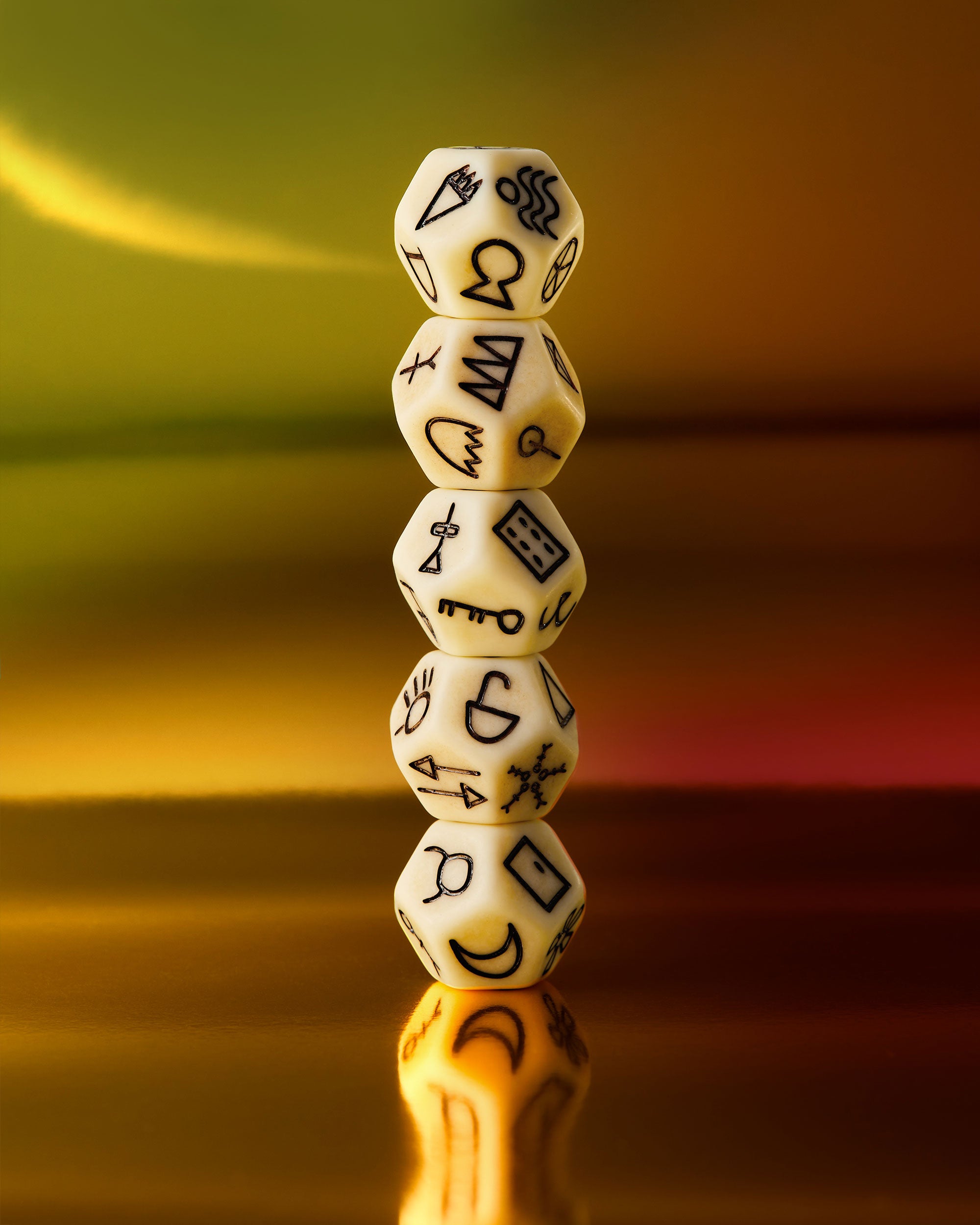 Stack of six-sided dice with symbols on a gradient background