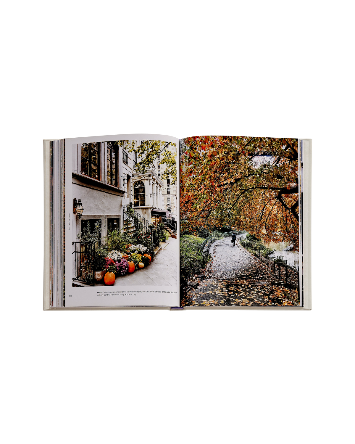 An open book showing two full-page lifestyle photographs side by side. The left page features a white house facade with a front porch decorated with pumpkins and flowers.